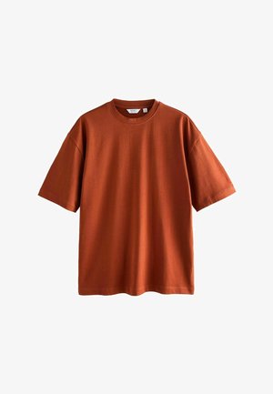 Rust-colored short-sleeve t-shirt made of soft cotton, featuring a round neckline and a relaxed fit. Smooth texture, no patterns or accents.