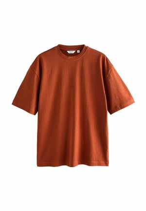 Kurzärmliges T-Shirt in Rostfarbe mit Rundhals, aus weichem Stoff gefertigt, mit lockerem Schnitt und minimalen Nähdetails.