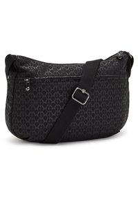 Black shoulder bag made of textured fabric featuring a geometric pattern, a zippered top, and an adjustable strap. Side pocket included.