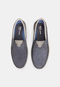 Tumed slip-on kingad tekstuuriga kangast, hallide aktsentidega, elastsete gore-paneelidega ja mustrilise siseosaga. Kummist välistald tagab haarde.