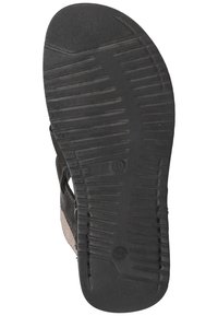 Black rubber sandal sole with textured tread pattern. Leather straps are visible along the edges, highlighting a sturdy design.