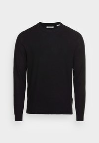 Pull noir en maille avec un col rond, des manches longues et des poignets côtelés. Présente un motif texturé sur toute la surface.