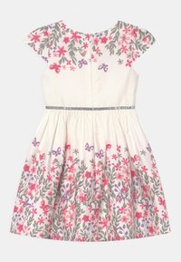 Kremowa sukienka z różowo-fioletowym nadrukiem kwiatów i motyli, z rękawami typu cap, marszczoną spódnicą oraz ozdobnym paskiem z srebrnego brokatu.
