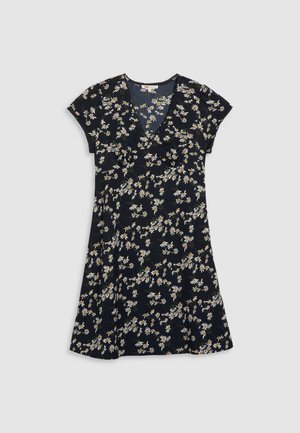 Blomstrete kjole med V-hals, korte ermer og flagrende skjørt. Har svart bakgrunn med hvite og gule tusenfryd mønstre.