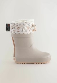Jasnobeżowe wodoodporne buty z teksturowaną gumową podeszwą, pikowaną, kwiatową cholewką i sznurkiem do regulacji dopasowania.