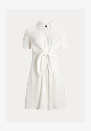 Robe courte en lin blanc avec manches courtes, col et détail noué à l'avant. Présente une coupe décontractée et une jupe légèrement évasée.