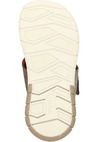 Lichtgekleurde rubberen buitenzool met een getextureerd grippatroon, met een beige basis en bruine accenten, ontworpen voor stabiliteit en grip.