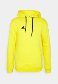 Sweat à capuche Adidas jaune vif avec logo noir sur la poitrine, cordons noirs, poche kangourou devant et manches longues.