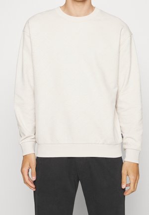 Sudadera de color beige claro con un patrón texturizado, cuello redondo y puños y dobladillo acanalados. Fabricada con una suave mezcla de telas para mayor comodidad.