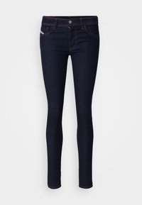 Mörkblå smala jeans i denimtyg. Har en medelhög midja, femficksdesign och kontrasterande orange sytningar.