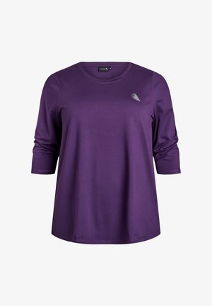 Paarse lange mouwen top met ronde halslijn en een subtiele zilveren accenten ontwerp op de borst. Gemaakt van gladde, elastische stof.