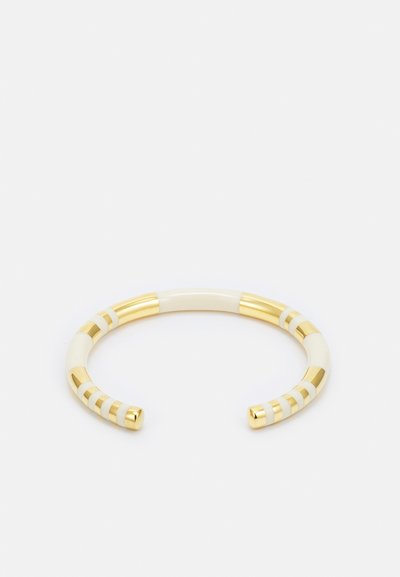 Gold-toned cuff bracelet featuring smooth ivory sections with alternating stripes. Open design allows for adjustable sizing.