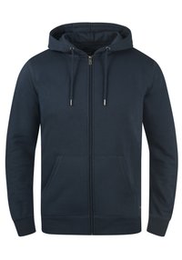 Navyblaues Zip-Hoodie aus einem weichen Baumwollmix, ausgestattet mit einer Kapuze, Kordeln, zwei Fronttaschen und gerippten Bündchen mit glatter Textur.
