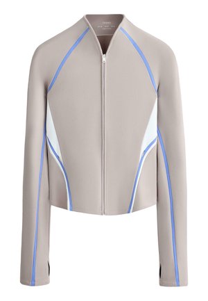 Beige zip-up jacket with long sleeves, white side panels, and blue piping details along sleeves and sides.