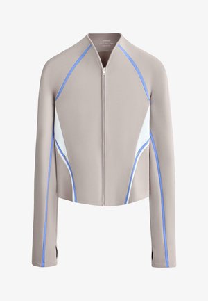 Beige zip-up jacket with long sleeves, white side panels, and blue piping details along sleeves and sides.