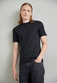 T-shirts imprimés de luxe MOSCHINO pour homme en ligne