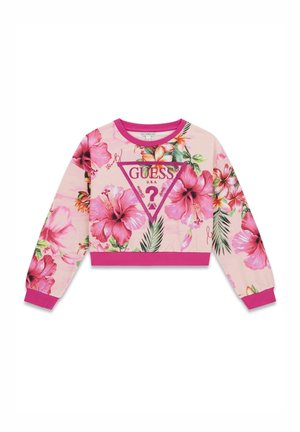 Sweat-shirt court rose avec de grandes fleurs d'hibiscus roses et des feuilles vertes, avec un logo GUESS central à l'intérieur d'un triangle.