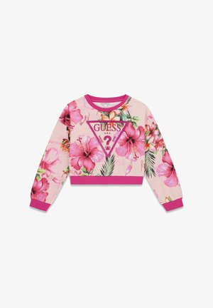 Sudadera corta rosa con grandes flores de hibisco rosas y hojas verdes, con un logo central de GUESS dentro de un triángulo.