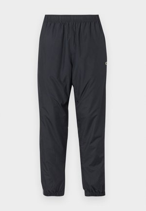 Pantalones de chándal negros, ligeros y resistentes al agua, con una cinturilla elástica y puños recogidos; con un diseño minimalista y un pequeño logo.