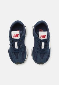 Navy blue sneakers featuring a mesh upper, suede accents, white details, and black rubber soles. Laces and branded tongue label included.