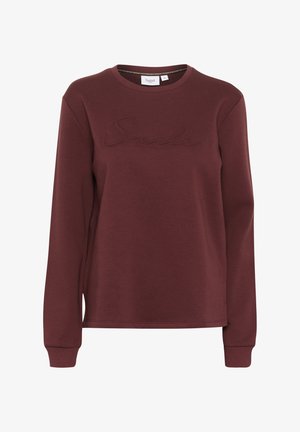 Burgundia pikkade varrukatega dressipluus, ümmarguse kaelakaelusega ja tõstetud "Smile" tikandiga rinnal. Valmistatud pehmest, struktureeritud kangast.