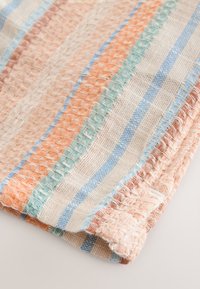 Woven fabric with orange, light blue, and beige stripes. Textured surface with prominent grid pattern and contrasting stitching along edges.