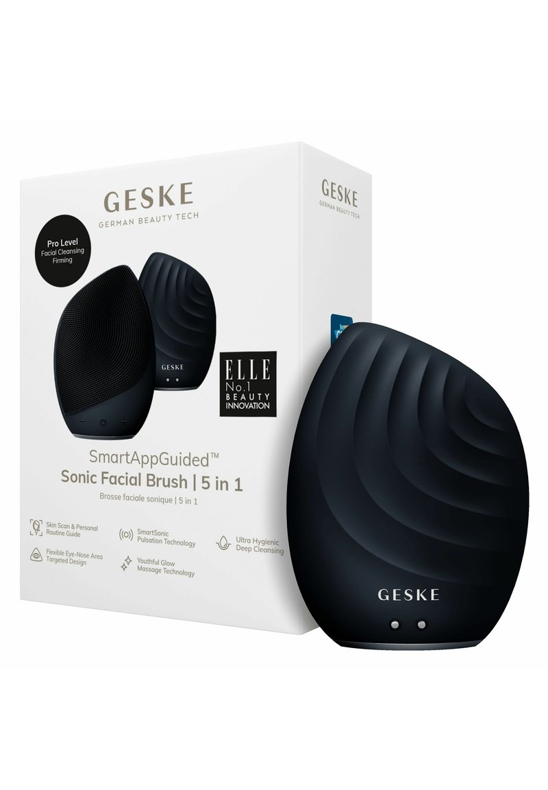 Brosse faciale sonique en silicone noire avec surface texturée, boutons de charge et branding du produit sur la boîte, affichant un design moderne et élégant.