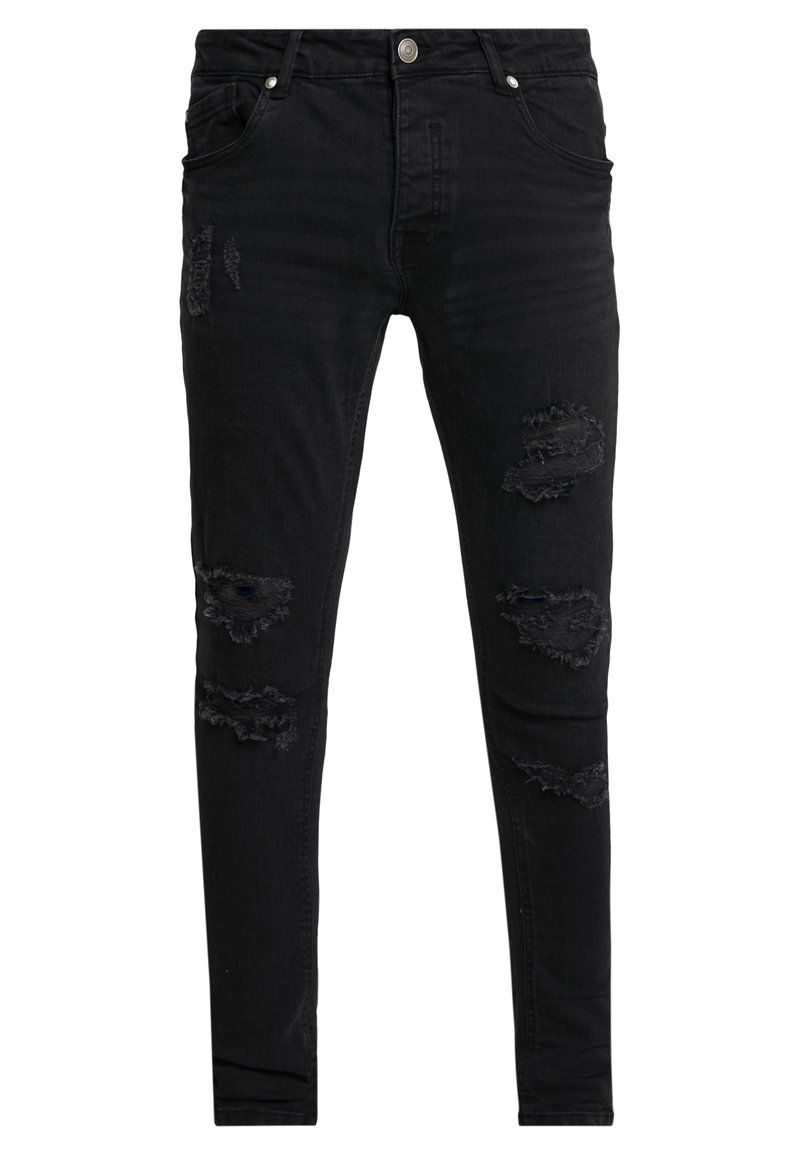 Pantalones vaqueros skinny negros hechos de denim, con acentos desgastados que presentan varios desgarros y bordes deshilachados. Bolsillos frontales y cierre de botón.