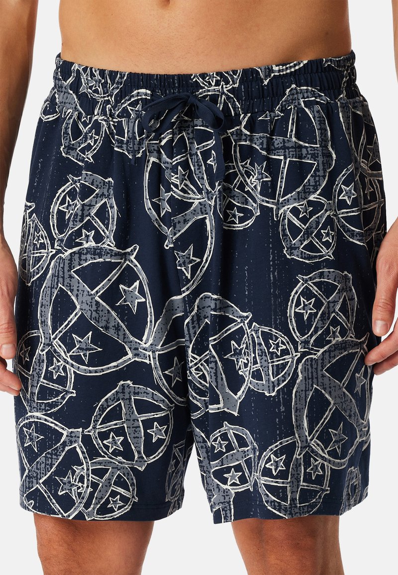 Shorts de bain navy avec une taille élastique, un cordon de serrage et un motif de étoiles blanches et circulaires. Tissu léger et à séchage rapide.