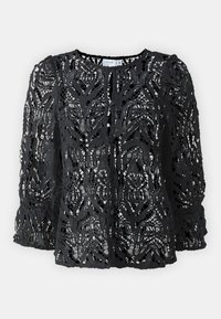 Blouse en dentelle noire ornée d'un motif floral, avec un col rond et de longues manches bouffantes au toucher texturé et un ourlet festonné.