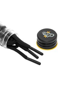 Black shoelaces with plastic tips, stored in a clear cylindrical container. Includes a round black cap with yellow accent and logo.