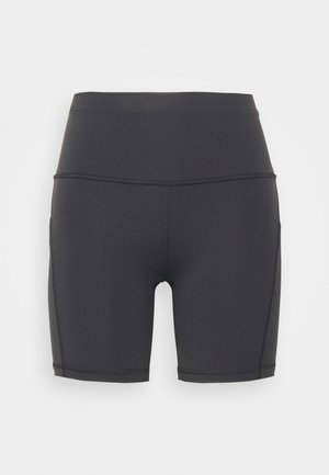Pantaloni sportivi neri realizzati in tessuto liscio ed elastico. Presentano una vita alta e un design senza cuciture con una vestibilità aderente.