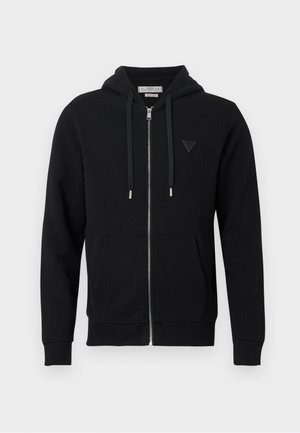 Black zip-up hoodie made of soft fabric. Features a hood, front pockets, and a triangular logo patch on the left chest. Smooth texture.
