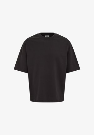 Camiseta negra lisa de manga corta y corte oversize con cuello redondo, mostrada de frente sobre un fondo blanco.