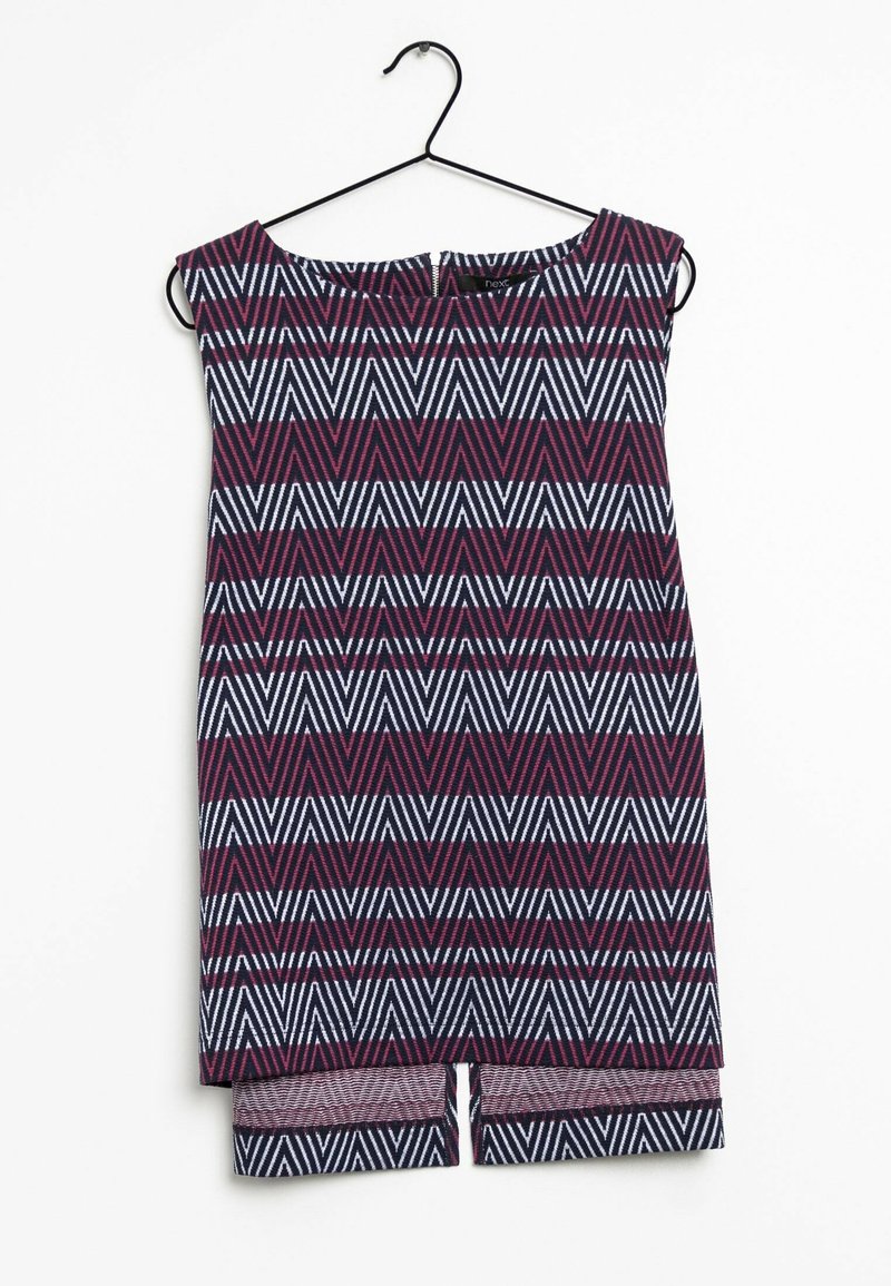 Robe sans manches avec motif chevrons en zigzag bordeaux, noir et blanc, suspendue sur un cintre en fil noir.