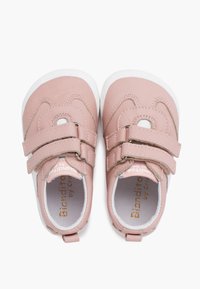 Pale pink leather shoes with white sole, featuring two hook-and-loop straps and rounded design. Inside shows branding detail.
