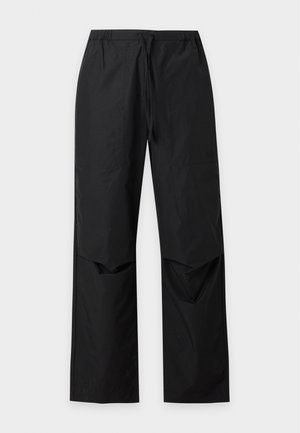 Pantalon léger noir avec taille élastique et cordon, jambes droites larges et design articulé au niveau des genoux.