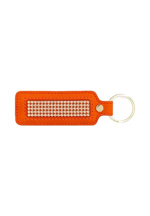 Oranje rechthoekige leren sleutelhanger met gouden ronde studs in het midden en metalen sleutelring bevestigd aan de rechterkant.