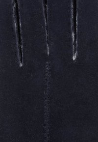 Dark navy leather with a soft texture, featuring two vertical slits and visible white stitching along the center seam.