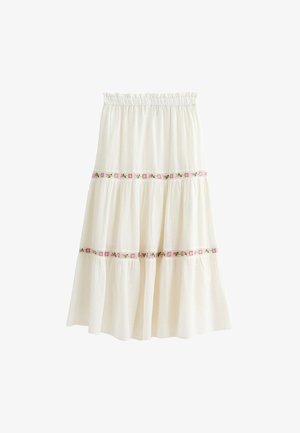 Biała spódnica warstwowa uszyta z lekkiego materiału, z różowym i zielonym haftem kwiatowym na warstwach oraz z elastycznym paskiem w talii.