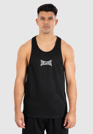 Black ribbed tank top with the logo "SMILODOX" in white. Features wide shoulder straps and a relaxed fit.