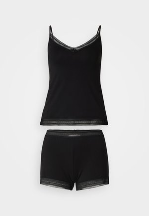 Black camisole with thin straps and lace trim, paired with matching lace-trimmed black shorts. Soft fabric, relaxed fit, simple design.