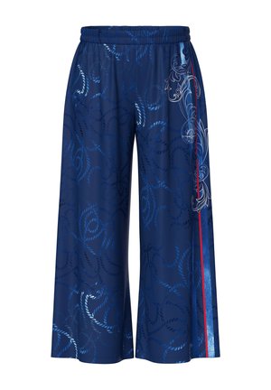 Pantalon large bleu marine avec un motif intégral de cordes, une bande verticale rouge et des arabesques blanches décoratives sur un côté.