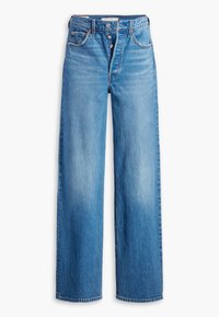 Jeans en denim bleu clair à taille haute, jambes larges, avec fermeture à boutons et cinq poches. Le tissu a une finition délavée et des détails de couture minimalistes.