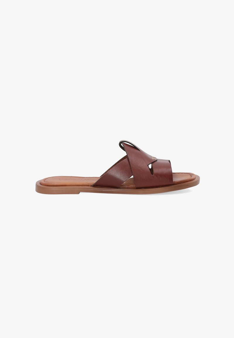 Brown leather slide sandal with two crossed straps featuring cut-out accents, flat tan sole, and smooth texture.