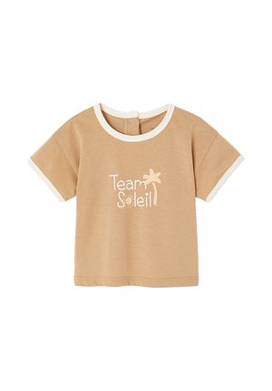 Beige short-sleeve toddler shirt with white trim, snap button closure at back, and "Team Soleil" text with sun and palm tree graphic on front.