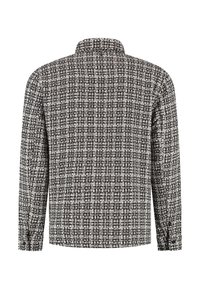 Hemd met lange mouwen in een zwart-wit houndstooth patroon, voorzien van een kraag en knoopmanchetten, gemaakt van een geweven stof.