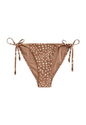 Brązowe dół bikini w białe kropki z regulowanymi wiązaniami po bokach z małymi koralikami na każdym końcu.