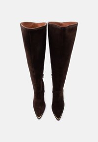 Ζευγάρι ψηλών, σκούρων καφέ σουέντ μπότες με μυτερά δάχτυλα και φερμουάρ στην εσωτερική πλευρά, παρουσιασμένες σε όρθια θέση σε λευκό φόντο.