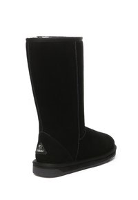 Black suede boot with a straight top, flat sole, and prominent stitching. Features a logo on the heel; smooth texture.